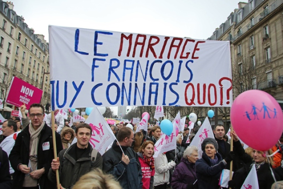 Sign says  "Marriage, Francois, what do you know about it?", a reference to un-married French President Francois Hollande